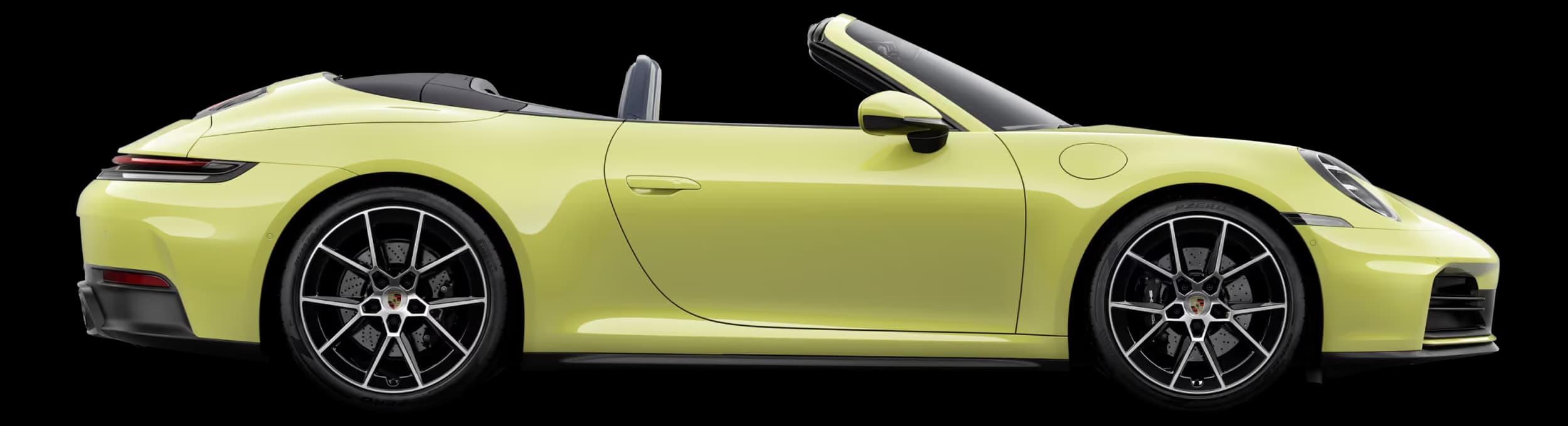 Porsche 911 Carrera Cabriolet in Cartagena Yellow Metallic with Black roof in profile/side view.